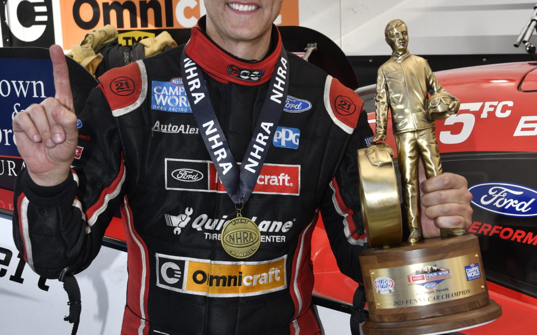Tasca holding trophy