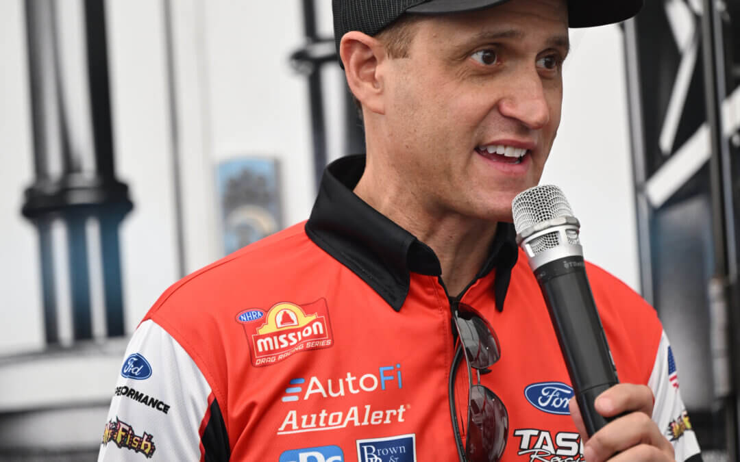 Bob Tasca holding a microphone