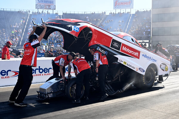 Tasca's car body being lowered onto vehicle