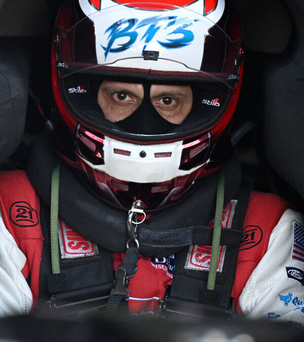 A view into the NHRA car looking at Bob Tasca in all his safety gear