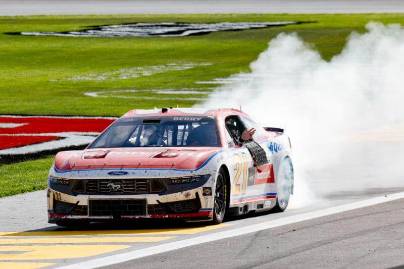 Front angled view of car number 21 doing a burnout
