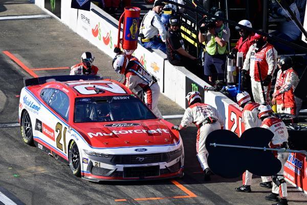 Action shot of the pit crew working on car 21