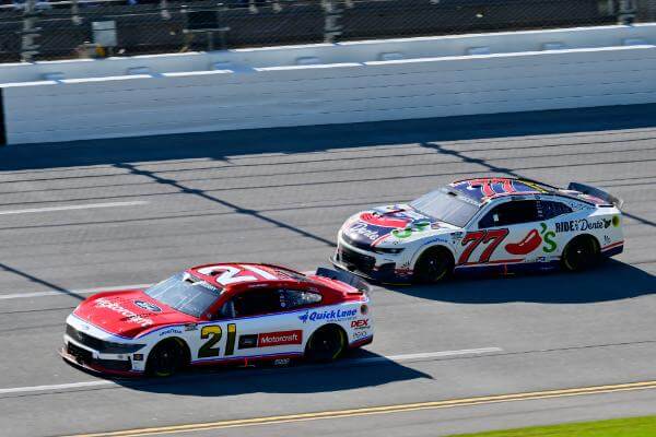 NASCAR 21 taking the lead from number 77 on track
