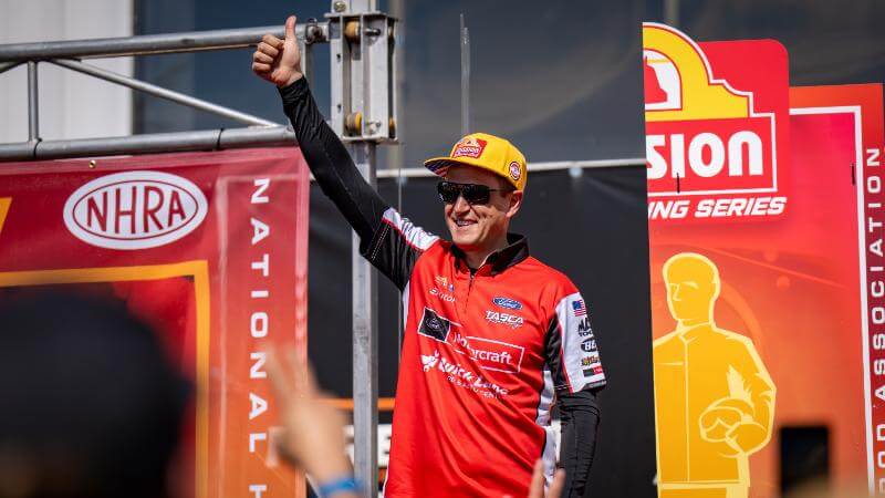 Tasca holding a thumb up to the crowd smiling