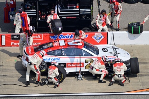 Pit crew in action on NASCAR number 21