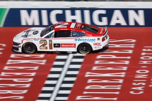 Number 21 NASCAR crossing the finish line at Michigan International Speedway