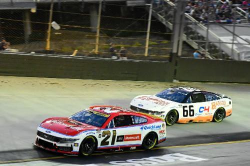 Night time shot of number 21 car and competitor on track