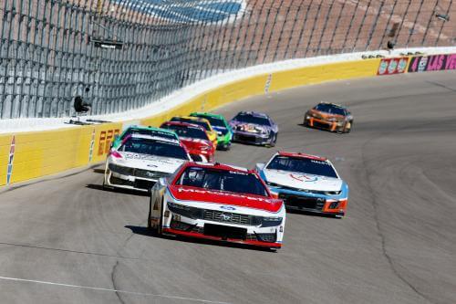 Head on view of many cars coming down the track with number 21 in front