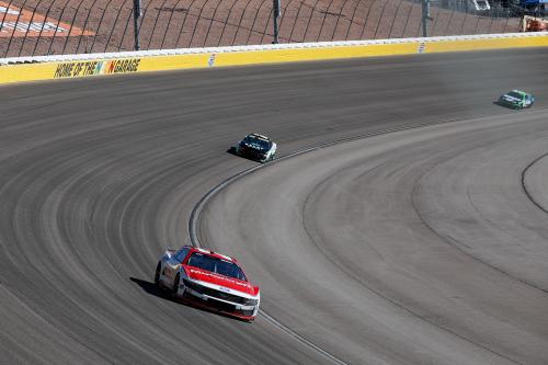 Far away view of cars on track at the corner