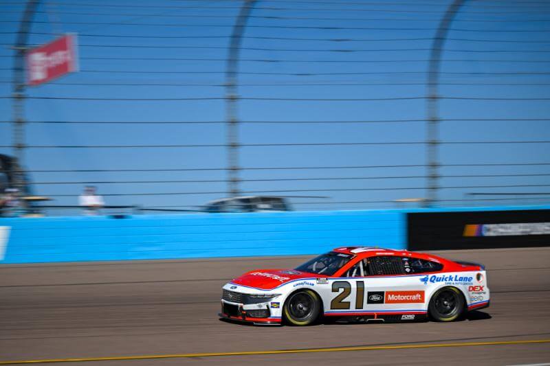 Side view of car number 21 with blue sky in the background