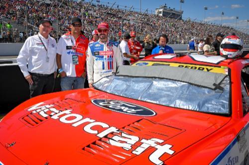 View of Josh and owners on track with a view of the red motorcraft logo hood