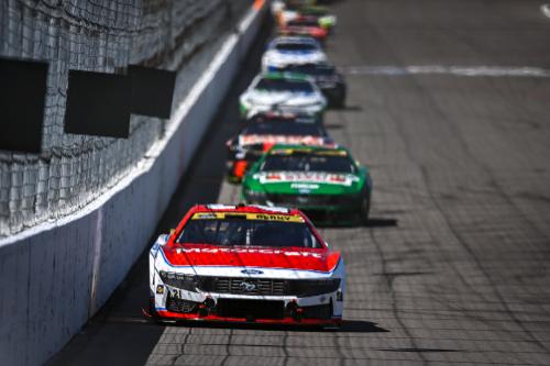 Head on view of cars on track with number 21 in front