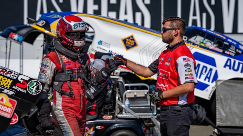Tasca fist bumping a crew member