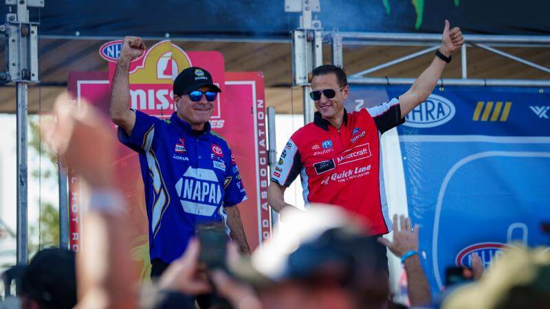 Tasca on stage with his arm in the air