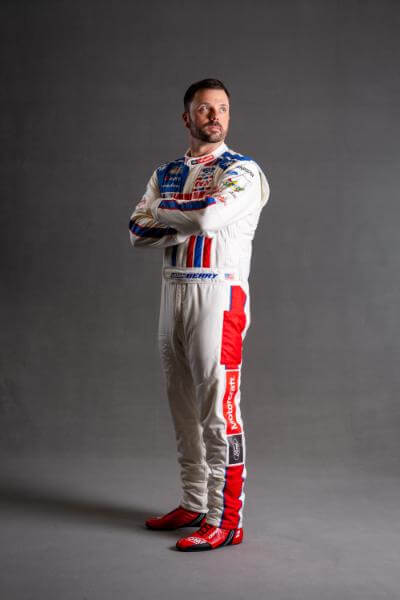 Josh Berry on a grey photoshoot background with arms crossed