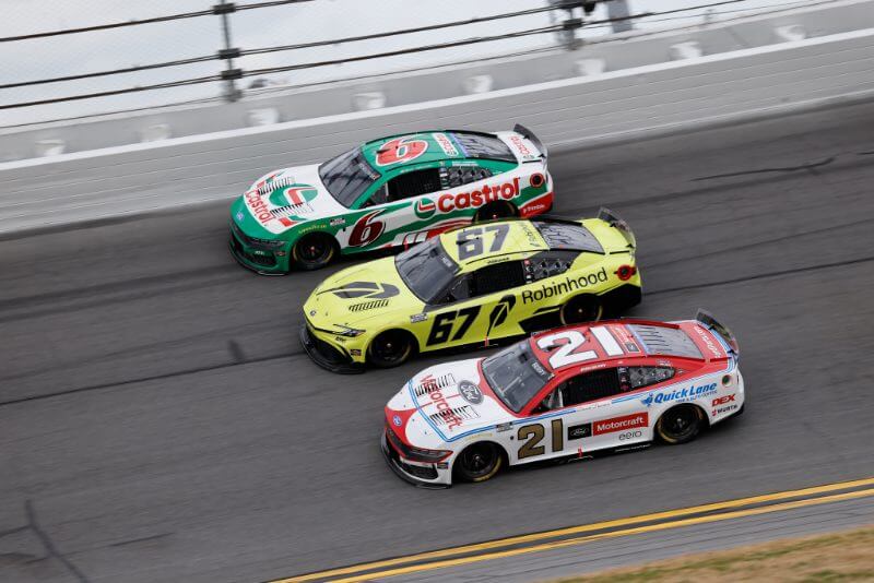 3 cars neck in neck battling for 1st place on track