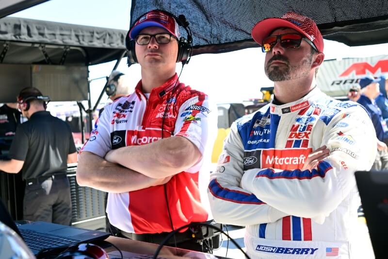 Josh Berry and pit crew standing with arms crossed
