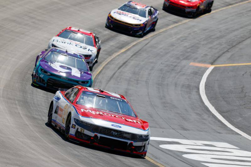 Front view of NASCARs coming around the corner
