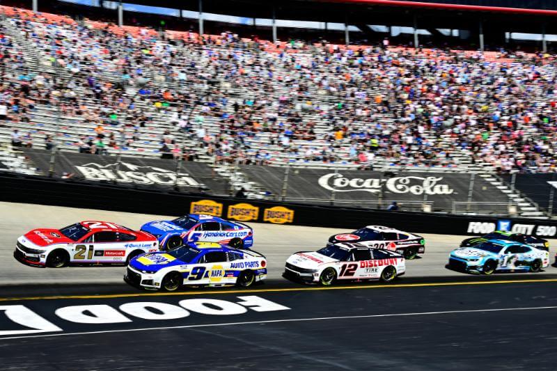 View of the cars going around the corner with filled bleachers