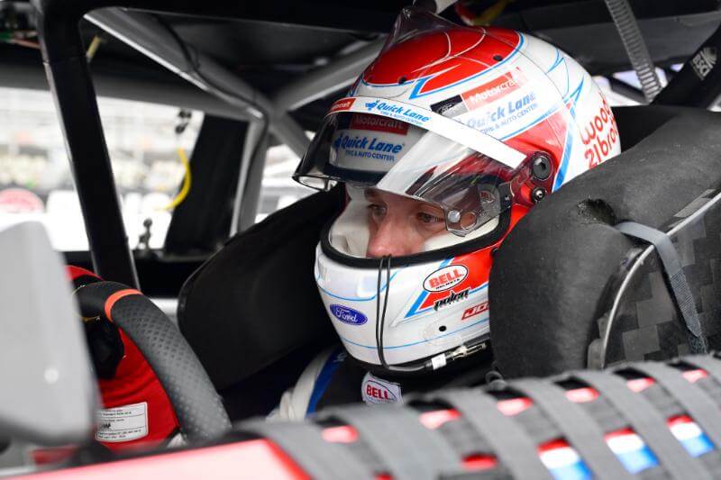 Up close shot of Barry in his helmet sitting in the drivers seat