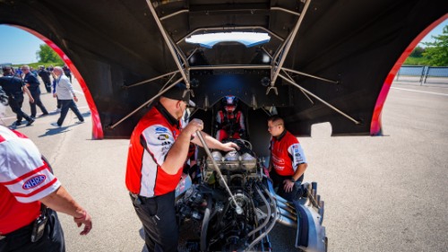 Austin and crew under the shell of the car